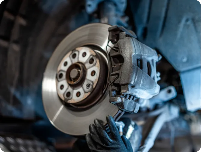 Person repairing vehicle brake system