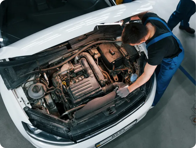 Mechanic inspecting car engine compartment