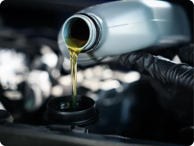 Pouring oil into a car engine