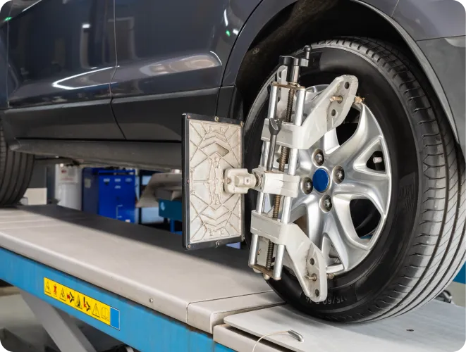 Car undergoing wheel alignment process